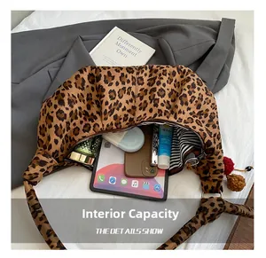 Detail view of large leopard print hobo bag with striped lining and high capacity