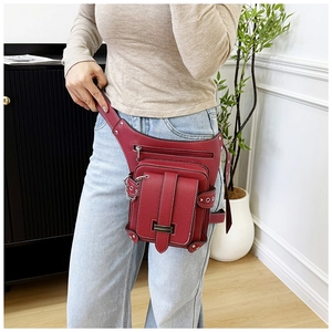 Close-up of burgundy waist bag with lychee grain texture and silver metal hardware details