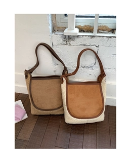 Detail of vintage-style patchwork tote bags with faux shearling and suede texture