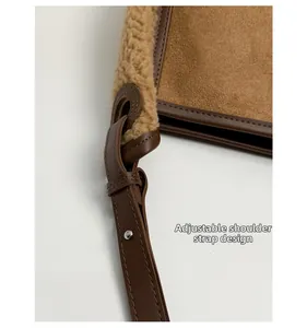 Detail of adjustable leather shoulder strap with shearling trim on a brown tote bag