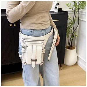 Detail of white leather waist bag with thigh strap and silver metal buckles