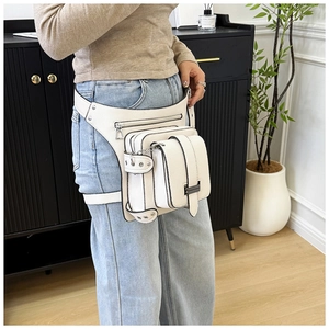 Detail of white lychee pattern leather thigh bag with metal chain and multi-pocket design
