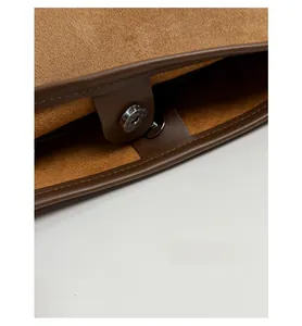 Detail view of the brown leather tote bag interior with magnetic snap closure