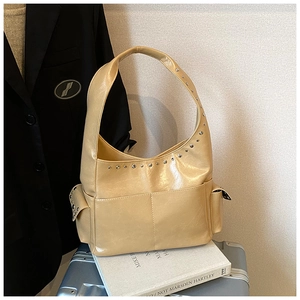 Detail view of vintage beige rivet shoulder bag with silver studs and pocket detail