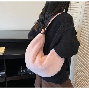 Détail du sac hobo en fausse fourrure rose avec bandoulière réglable sur le mannequin