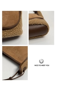 Detail view of brown suede stitching with cream faux fur fleece on a bucket tote bag