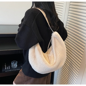 Detail of soft cream faux fur hobo bag with sleek zipper and adjustable shoulder strap