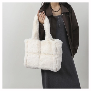 Detail of white faux fur tote bag showing plush quilted pattern and woven texture
