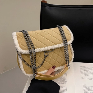 Quilted yellow shoulder bag with plush shearling trim and silver chain strap for autumn