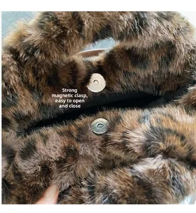 Detail view of the secure magnetic snap closure on the leopard print faux fur handbag