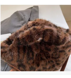 Detailed view of the soft faux fur leopard print texture and sturdy round handles