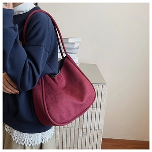 Detailed texture of burgundy suede tote bag showing premium matte finish and fine seams