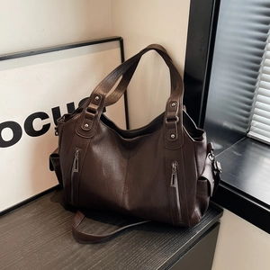 Retro dark brown large tote bag with vertical zipper pockets in natural sunlight
