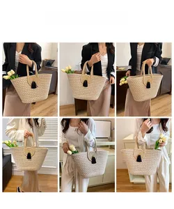 Detail view showing woven straw tote bag with black tassel charm and elegant ring handle design