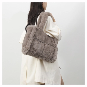 Detail of soft plush woven texture on large tote bag with wide shoulder strap