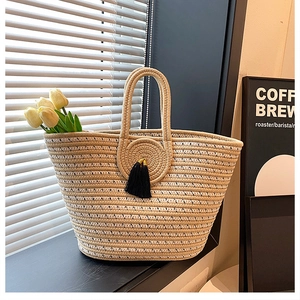 Detailed weave pattern on handmade tote bag with decorative tassel and interior flowers