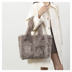 Detail of grey plush tote bag with quilted checkerboard pattern and fuzzy top handles