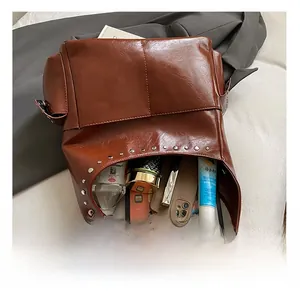 Detail shot of the spacious interior of a vintage brown rivet tote showing storage capacity
