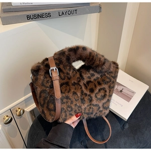 Detail shot of leopard print faux fur handbag with brown leather strap and silver buckle