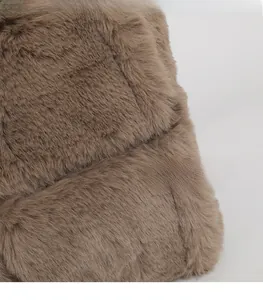 Close-up detail showing the soft texture of brown faux fur fabric on the handbag