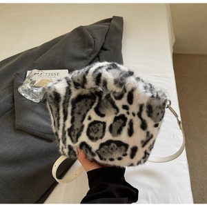 Close-up of leopard print faux fur bag with leather strap and silver metal hardware