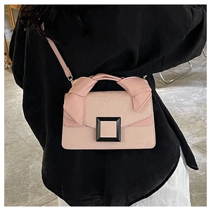 Detail of pink snake pattern handbag featuring a black square buckle and ribbon handle