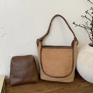 Fleece and faux suede bucket bag set with inner pouch on minimalist wooden background