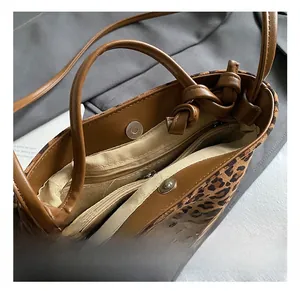 Close-up of leopard print bucket bag interior with magnetic clasp and zipper pocket