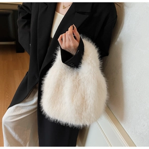 Close-up of white fluffy plush handbag texture with model wearing black blazer