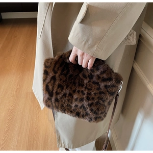 Detail of leopard print faux fur handbag with plush handle and silver hardware accent