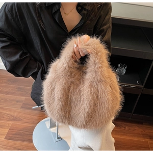 Detail of soft brown faux fur handbag texture with plush finish and integrated handle