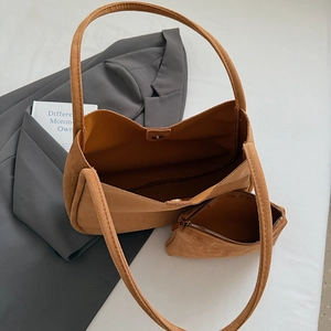 Macro detail of the brown matte suede tote bag set with a matching zipper coin purse