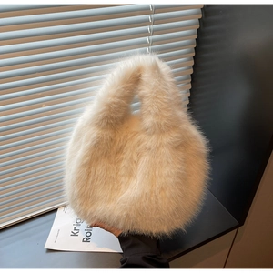 Detail of soft cream faux fur texture on this plush handbag with natural window light