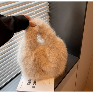 Close-up of fluffy beige faux fur handbag texture on marble table near window
