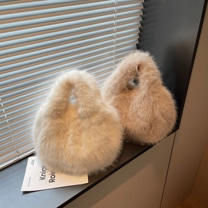 Close-up of soft faux fur handbags in cream and light brown with spherical design