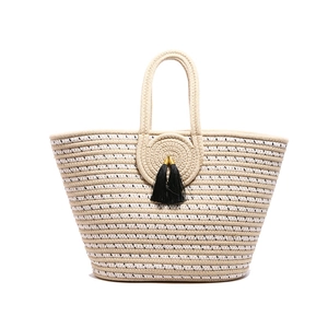 Fashion woven tote bag with beige stripes, circular pattern, and black tassels
