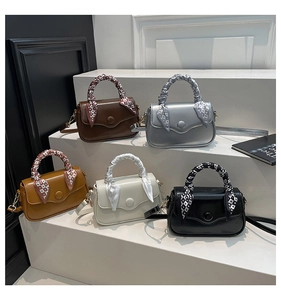 Five stylish crossbody bags in various colors with decorative silk scarves on steps