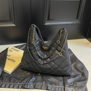 Quilted black leather tote bag with gold chain strap and elegant diamond lattice texture