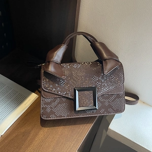 Brown faux snakeskin handbag with vintage square buckle and knotted handle detail