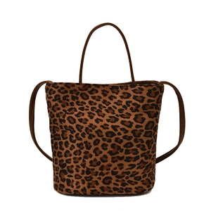 Retro leopard print bucket bag with brown handles and shoulder strap on white background