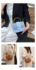 Close-up of small vintage box bag featuring bamboo handle and golden buckle detail