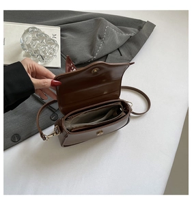 Detail view of the brown retro bag interior with magnetic clasp and zipper pocket