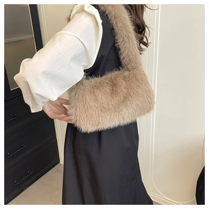 Close-up of khaki faux fur shoulder bag texture and plush material on model