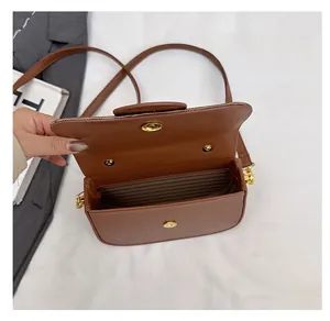 Detailed interior view of the brown leather crossbody box bag with magnetic closure