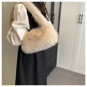 Detail of soft beige faux fur shoulder bag with plush fluffy texture and matching strap