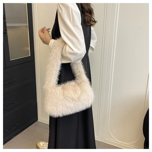 Detailed close-up of light beige faux fur texture on a trendy plush handbag