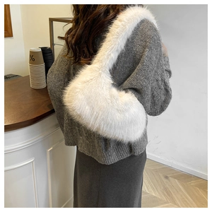 Close-up of white faux fur shoulder bag texture and fluffy crescent moon design