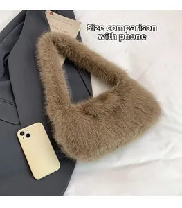 Brown faux fur shoulder bag next to a smartphone showing its compact portable size