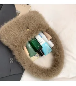 Interior view of brown plush handbag showing large capacity for cosmetics and phone