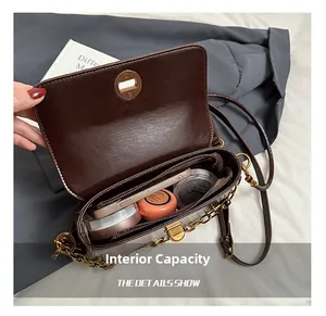 Detail view of large interior capacity with zipper pocket for brown crossbody bag